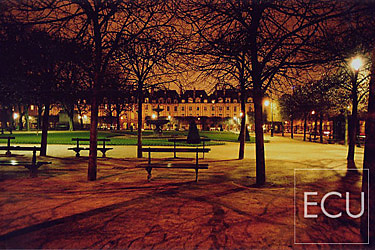 Color photo of the Place des Vosges on the Right Bank in Paris, France at night exemplifying landscape architecture of Henri IV