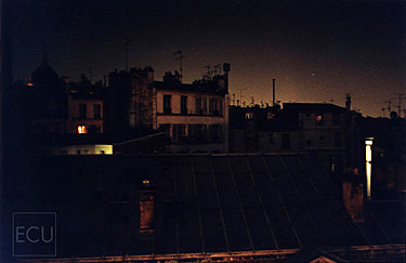 Color photograph of Parisian rooftops shot from H&ocirc;tel des Academies on rue de la Grande Chaumi&egrave;re in Montparnasse and 6th arrondisement in Paris, France
